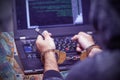 Criminal hacker hands locked in handcuffs. Closeup view