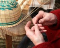 hands with arthrosis of the old lady as she creates a wicker bas