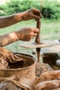 Hands of a artisan creating new clay shape from brown clay