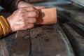 Hands of an artisan embossing in leather