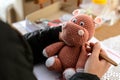 Hands of an artisan creating a plush hippo using the amigurumi crochet technique Royalty Free Stock Photo