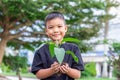 Hands Asian child boy holding a little green plant with soil. Growing tree. Royalty Free Stock Photo