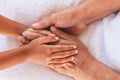 Hands of asian child girl holding elderly grandparent hands wrinkled skin