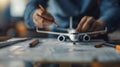 Hands assembling a model airplane on a table