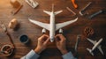 Hands assembling a model airplane on a table
