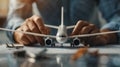 Hands assembling a model airplane on a table