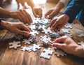 Hands assembling a mosaic of interlocking puzzle pieces Royalty Free Stock Photo