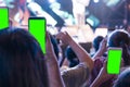 Hands of audience crowd people taking photo with mobile smart phone with green screen in party concert Royalty Free Stock Photo