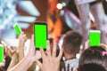 Hands of audience crowd people taking photo with mobile smart phone with green screen in party concert Royalty Free Stock Photo