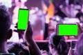 Hands of audience crowd people taking photo with mobile smart phone with green screen in party concert Royalty Free Stock Photo