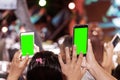 Hands of audience crowd people taking photo with mobile smart phone with green screen in party concert Royalty Free Stock Photo