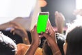 Hands of audience crowd people taking photo with mobile smart phone with green screen in party concert Royalty Free Stock Photo