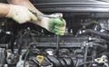 Hands of an auto mechanic with a socket wrench in the engine compartment of a car during repairs Royalty Free Stock Photo