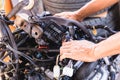 Hands of Auto mechanic working on car engine in mechanics garage, Repair and Maintenance service Royalty Free Stock Photo