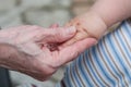 Hands of baby grandson and old grandmother, concept of family re Royalty Free Stock Photo