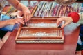 Hands of backgammon players. Two people are playing at the retro board. Historical reconstruction of board eastern game of Royalty Free Stock Photo