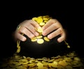 Hands on a bag of gold coins