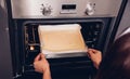 Hands of baker holding dough bread fresh on front oven Royalty Free Stock Photo