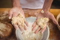 Hands of baker mixing flour by hand