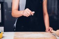 Hands of baker woman female making sprinkling flour dough Royalty Free Stock Photo