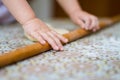 Hands baking dough with rolling pin on table. little chef bake in kitchen. Royalty Free Stock Photo