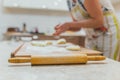 Hands baking dough with rolling pin on wooden table Royalty Free Stock Photo