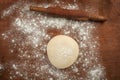 Hands baking dough with rolling pin on wooden table Royalty Free Stock Photo