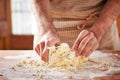 Hands baking dough on wooden table