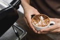 Hands of barista holding a cup of Latte coffee Royalty Free Stock Photo