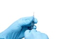 Hands of the beautician in blue gloves holding syringe. The cosmetologist prepares for a injection cosmetology procedure. Isolated Royalty Free Stock Photo