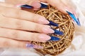 Hands with beautiful long artificial blue french manicured nails Royalty Free Stock Photo