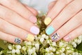 Hands with beautiful manicured nails and lily of the valley flowers