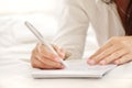 Hands of a beautiful young woman writing on a pad Royalty Free Stock Photo