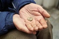 Hands of beggar with one euro coin begging for money Royalty Free Stock Photo