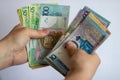 Hands with Belarusian money on a white background. Belarusian currency on a white background