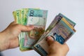 Hands with Belarusian money on a white background. Belarusian currency on a white background