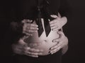 Hands and Belly - Pregnant woman belly holding hands of mother, father and child Royalty Free Stock Photo
