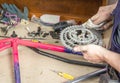 Hands of bicycle mechanic cleaning chainring bike