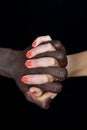 A hands of black man and white woman on black