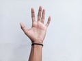 Hands and black rubber band on wrist on white background.