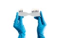 Hands in blue gloves holding dental color palette isolated