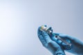 Hands in blue latex gloves fill in syringe with vaccine from glass vial. Vaccination and medical concept Royalty Free Stock Photo