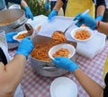 meal distribution with pasta and tomato sauce in the canteen Royalty Free Stock Photo