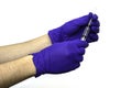 Hands in blue protective medical gloves hold a syringe on the white background Royalty Free Stock Photo