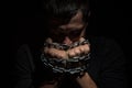 Hands bound in metal chains on a black background Royalty Free Stock Photo