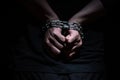 Hands bound in metal chains on a black background Royalty Free Stock Photo