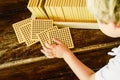 Hands of boy manipulating counting cubes on wooden background in montessori classroom