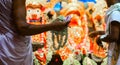 Hands of Brahmin Purohit Panda offering white tuberose rajanigandha flowers to lord jagannath balaram suvadra during rath yatra fe