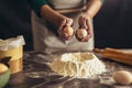 Hands breaking egg into raw dough on wooden table Royalty Free Stock Photo
