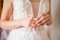 The hands of the bride with gold wedding ring with a diamond. Bride`s Preparations. Wedding Morning. Jewelry. Manicure close up. Royalty Free Stock Photo